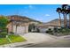 Spacious home featuring a three-car garage, well-maintained landscaping, and a circular driveway at 10829 Ickworth Ct, Las Vegas, NV 89135