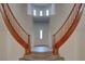 Welcoming foyer with beautiful tile flooring and split staircase leading to upper level at 10829 Ickworth Ct, Las Vegas, NV 89135