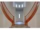 Welcoming foyer with beautiful tile flooring and split staircase leading to upper level at 10829 Ickworth Ct, Las Vegas, NV 89135