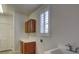 Practical laundry room with storage cabinets and a convenient utility sink at 10829 Ickworth Ct, Las Vegas, NV 89135