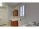 Convenient laundry room with white countertops, sink and wood cabinetry at 10829 Ickworth Ct, Las Vegas, NV 89135