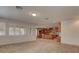 Open living room with tile floors and large windows with views of the kitchen at 10829 Ickworth Ct, Las Vegas, NV 89135