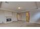 Spacious living room with a fireplace, plush carpet, and a tray ceiling with recessed lighting at 10829 Ickworth Ct, Las Vegas, NV 89135