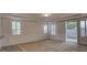 Bright living room features plantation shutters, neutral carpet and access to outdoor space at 10829 Ickworth Ct, Las Vegas, NV 89135