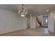 Open-concept living room boasts elegant chandelier and staircase to the front entry at 10829 Ickworth Ct, Las Vegas, NV 89135