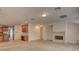 Open-concept living room featuring a fireplace and adjacent gourmet kitchen at 10829 Ickworth Ct, Las Vegas, NV 89135