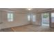 Bright living room features plantation shutters, neutral carpet and access to outdoor space at 10829 Ickworth Ct, Las Vegas, NV 89135
