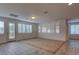 Bright living room features multiple windows with modern shutters and tile flooring at 10829 Ickworth Ct, Las Vegas, NV 89135