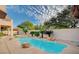 Backyard oasis featuring a sparkling pool, a relaxing spa, and mature tropical landscaping at 10829 Ickworth Ct, Las Vegas, NV 89135
