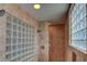 Modern shower with glass block wall and tiled walls at 10829 Ickworth Ct, Las Vegas, NV 89135