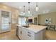Bright kitchen with white cabinets, stone countertops, stainless appliances, and eat in island at 10943 Doresta Ave, Las Vegas, NV 89166