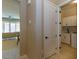 Hallway view to the laundry room with white cabinets and appliances at 10943 Doresta Ave, Las Vegas, NV 89166