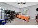 Comfortable bedroom featuring neutral walls, ceiling fan and large window at 11023 Ketchikan St, Las Vegas, NV 89179