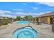 Community pool and hot tub with surrounding lounge chairs and well-maintained landscaping at 11023 Ketchikan St, Las Vegas, NV 89179