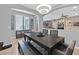 Inviting dining room featuring modern light fixture, sleek table with bench seating, and decoratively-framed Gathering pictures at 11023 Ketchikan St, Las Vegas, NV 89179