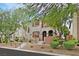 Charming two-story townhome featuring desert landscaping, red shutters, and a welcoming entrance at 11023 Ketchikan St, Las Vegas, NV 89179