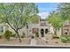 Charming two-story home featuring stucco exterior, red shutters, a balcony, and tasteful landscaping at 11023 Ketchikan St, Las Vegas, NV 89179