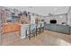 Modern kitchen open to living area, featuring an island with seating, and stainless-steel appliances at 11023 Ketchikan St, Las Vegas, NV 89179