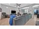 Well-lit living room with a large sectional, media center, and open design at 11023 Ketchikan St, Las Vegas, NV 89179
