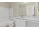 Bright bathroom with a tub, shower, large mirror and single sink vanity with white cabinets and countertop at 11076 Zampino St, Las Vegas, NV 89141