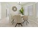 Cozy dining area features a modern light fixture, decorative mirror, and a table with four chairs at 11076 Zampino St, Las Vegas, NV 89141
