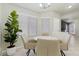 Bright dining area featuring a round table, four chairs, large window, and potted plant at 11076 Zampino St, Las Vegas, NV 89141