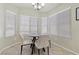 Bright dining area with natural light, featuring modern table and four chairs at 11076 Zampino St, Las Vegas, NV 89141