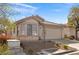 Well-maintained single-story home featuring a two-car garage and desert landscaping, providing curb appeal at 11076 Zampino St, Las Vegas, NV 89141