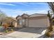 Charming single story house with a large two-car garage, driveway, and desert landscaping at 11076 Zampino St, Las Vegas, NV 89141