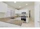 Modern kitchen featuring granite countertops, stainless steel appliances, and ample cabinet space at 11076 Zampino St, Las Vegas, NV 89141