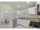 Kitchen with white cabinets, granite counters, stainless steel appliances, and attached dining area at 11076 Zampino St, Las Vegas, NV 89141