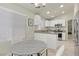 Kitchen with white cabinets, granite counters, stainless steel appliances, and attached dining area at 11076 Zampino St, Las Vegas, NV 89141