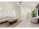 Spacious living room with stylish furniture, tiled flooring, and an open layout, ideal for gatherings at 11076 Zampino St, Las Vegas, NV 89141