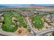 This aerial view showcases a lush golf course community with beautiful homes and scenic mountain views at 1172 Strada Pecei, Henderson, NV 89011