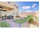 Enjoy outdoor living on this backyard patio with outdoor seating, rock landscape design, and synthetic grass at 1172 Strada Pecei, Henderson, NV 89011