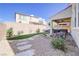 Well-maintained backyard featuring a covered patio and beautiful plants and landscaping at 1172 Strada Pecei, Henderson, NV 89011