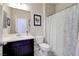 Bathroom featuring vanity with mirror, commode and shower with blue and white curtain at 1172 Strada Pecei, Henderson, NV 89011