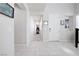 Spacious entryway with white tile, white walls, and view down hallway at 1172 Strada Pecei, Henderson, NV 89011