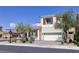 Well-kept two-story home with a two-car garage, red shutters, and desert landscaping at 1172 Strada Pecei, Henderson, NV 89011
