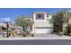 Well-kept two-story home with a two-car garage, red shutters, and desert landscaping at 1172 Strada Pecei, Henderson, NV 89011