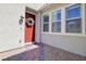 Close up of the red front door with wreath and brick pathway leading up to the entrance at 1172 Strada Pecei, Henderson, NV 89011
