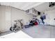 A well-organized two-car garage with overhead storage racks and ample space for parking and storage at 1172 Strada Pecei, Henderson, NV 89011