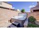 Backyard hot tub nestled in a brick-walled space for privacy and relaxation on a paver and gravel area at 1172 Strada Pecei, Henderson, NV 89011