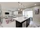 Kitchen island featuring a sink and dishwasher with an open view of the living room at 1172 Strada Pecei, Henderson, NV 89011