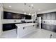 Bright kitchen featuring stainless steel appliances, an island, and dark wood cabinets at 1172 Strada Pecei, Henderson, NV 89011