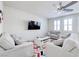 Cozy living room has a ceiling fan, TV, neutral furniture, and bright colorful rug at 1172 Strada Pecei, Henderson, NV 89011