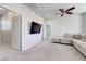Comfortable living room with plush carpet, sectional sofa, and wall-mounted flat screen TV at 1172 Strada Pecei, Henderson, NV 89011