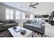 Bright living room with view to kitchen, ceiling fan, and shutters at 1172 Strada Pecei, Henderson, NV 89011