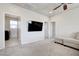 Spacious living room features plush carpet, a flat screen TV, and comfortable seating at 1172 Strada Pecei, Henderson, NV 89011
