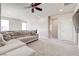 Spacious living room features plush carpet, a large sectional couch, and a flat screen TV at 1172 Strada Pecei, Henderson, NV 89011